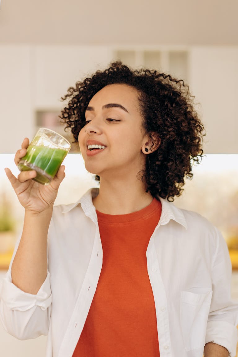 Woman drinking water with collagen showing tasteless bovine collagen powder dissolved in beverage